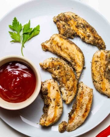 instant pot chicken tenders on gray dish next to ketchup sauce