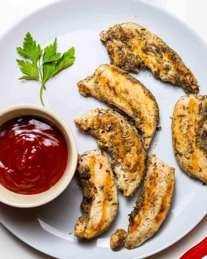 instant pot chicken tenders on gray dish next to ketchup sauce