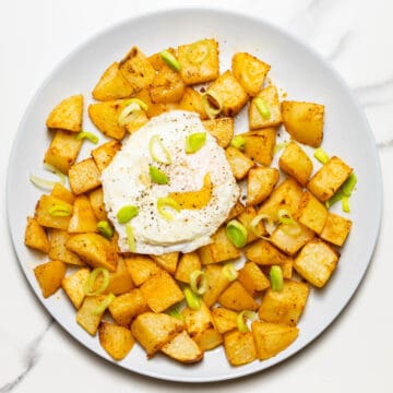 overlay photo of air fryer breakfast potaotes on grey dish on a white surface