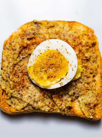 avocado toast with boiled egg on a grey dish