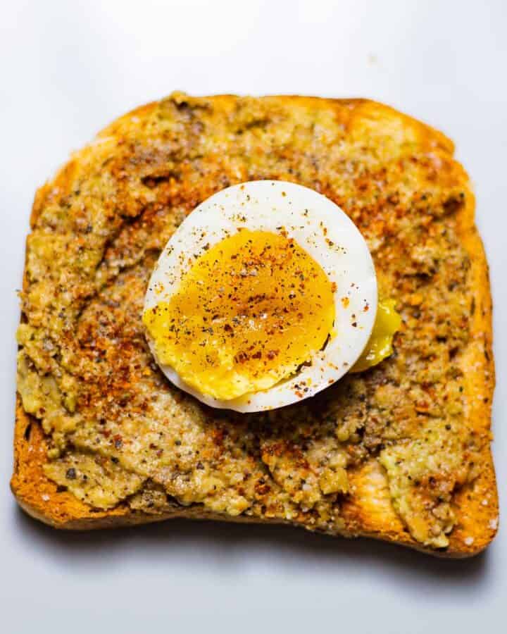 avocado toast with boiled egg on a grey dish