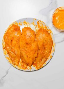 3 chicken breasts rubbed with buffalo sauce