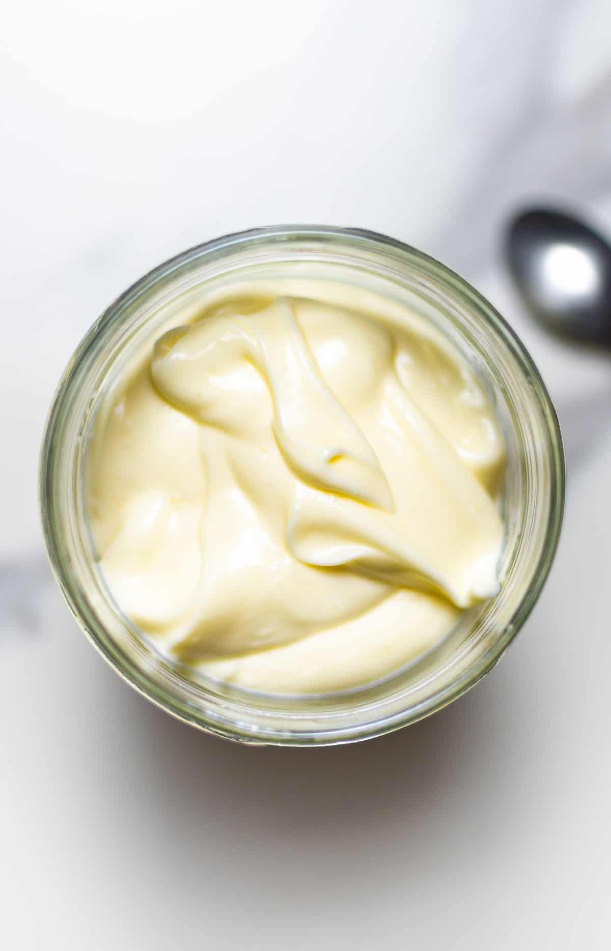 close-up of a jar of mayonnaise in a white background