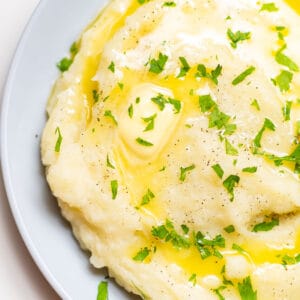 close-up of creamy garlic mashed potatoes with parsley on top