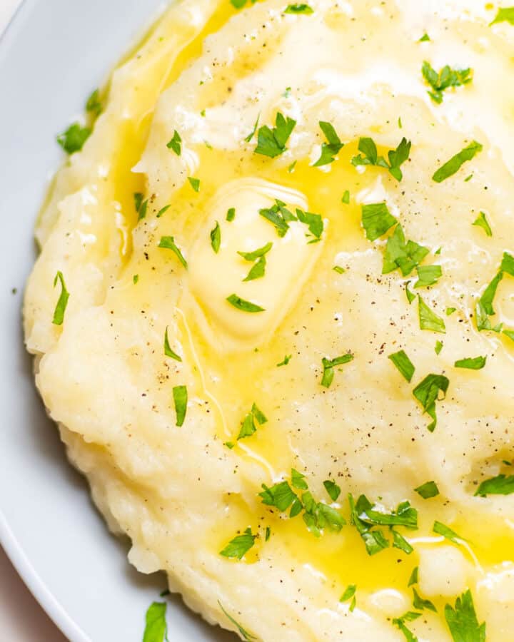 close-up of creamy garlic mashed potatoes with parsley on top