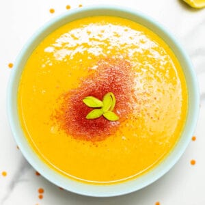 close-up of a bowl with lentil soup and chili powder on top