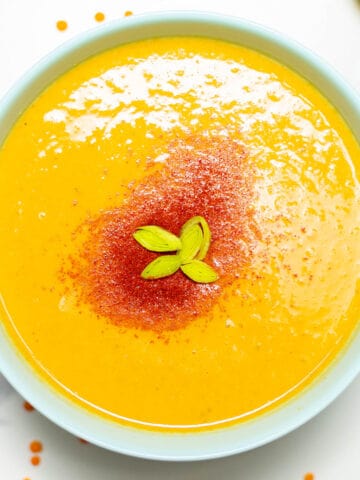 close-up of a bowl with lentil soup and chili powder on top