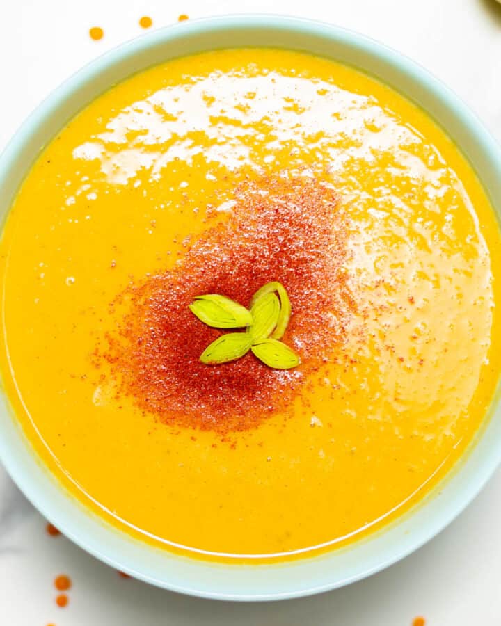 close-up of a bowl with lentil soup and chili powder on top