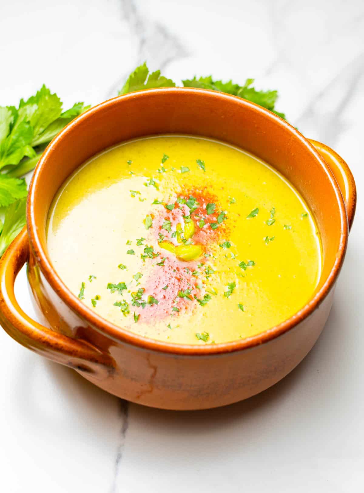 carrot and celery soup on stone pot side view