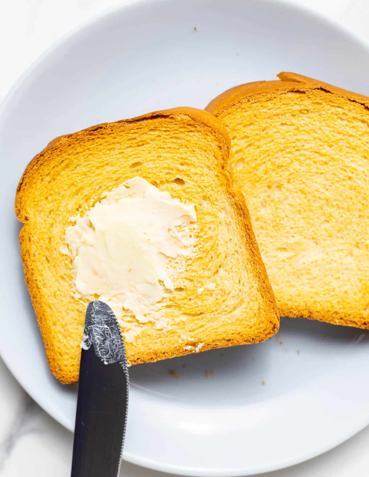 toast with oven on a plate with butter.