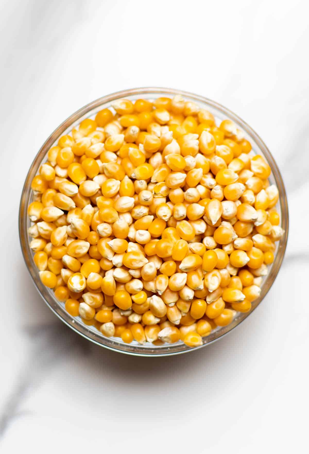overlay shot of popcorn kernels in a glass bowl
