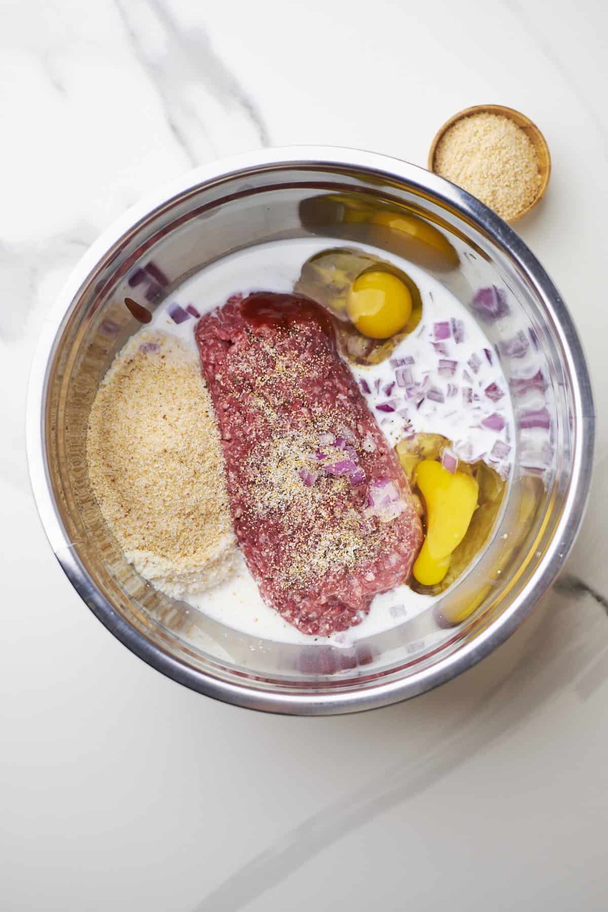 ingredients for meatloaf in mixing bowl.