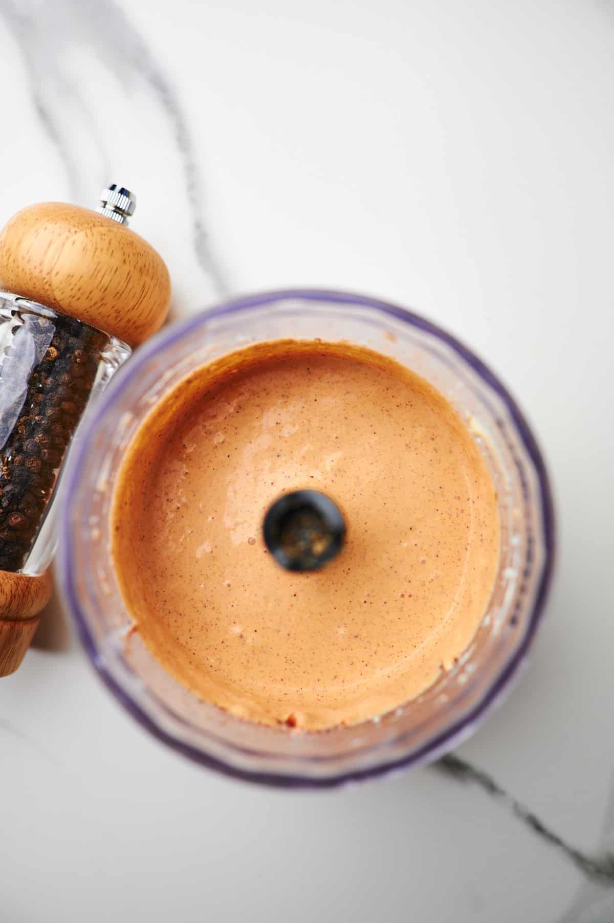 Food processor filled with creamy jalapeno sauce for quesadillas.