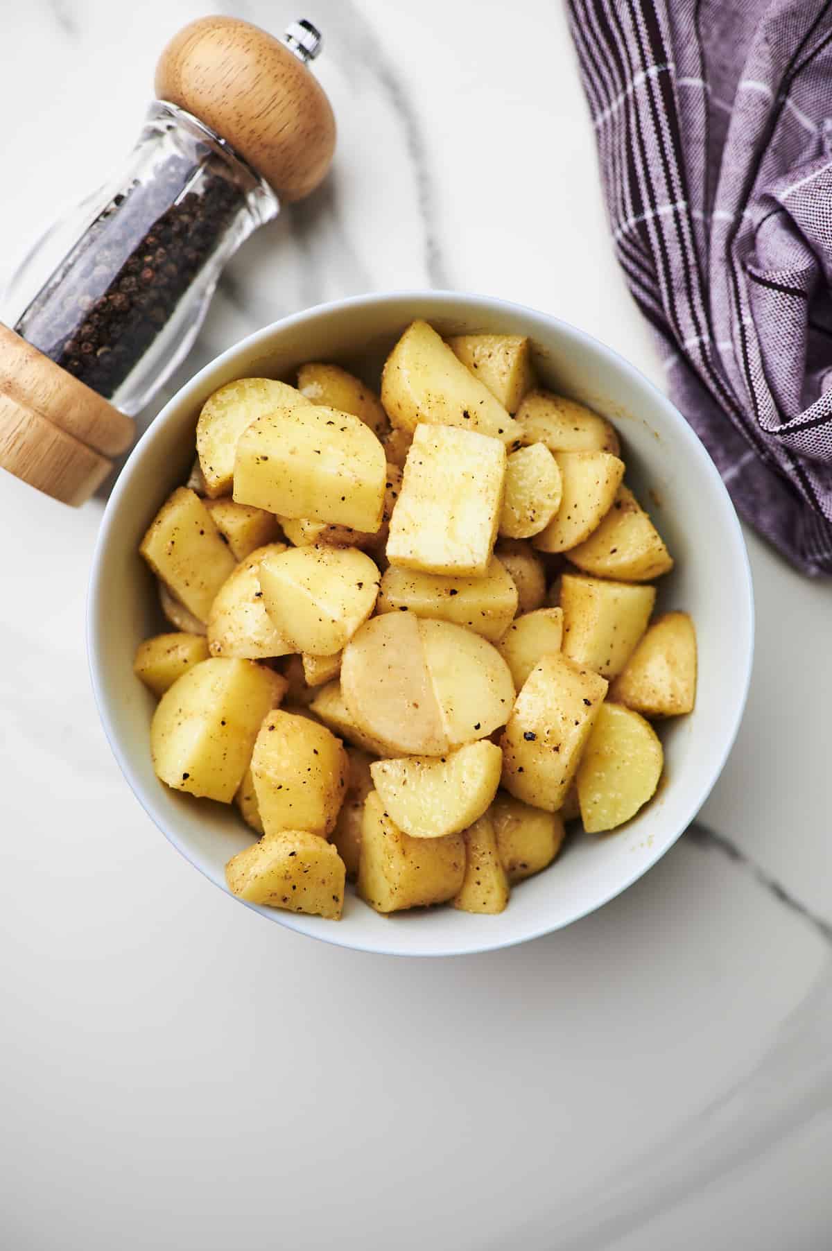 seasoned potatoes in mixing bowl.