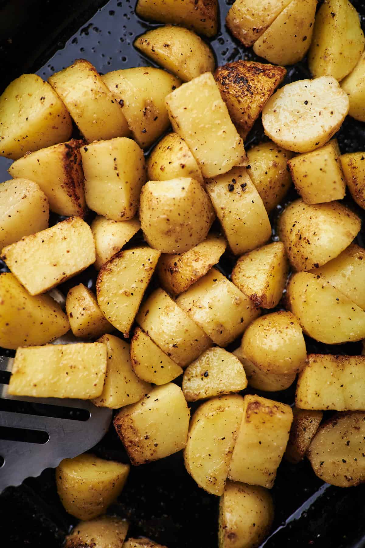 toss potatoes with grilling spatula.