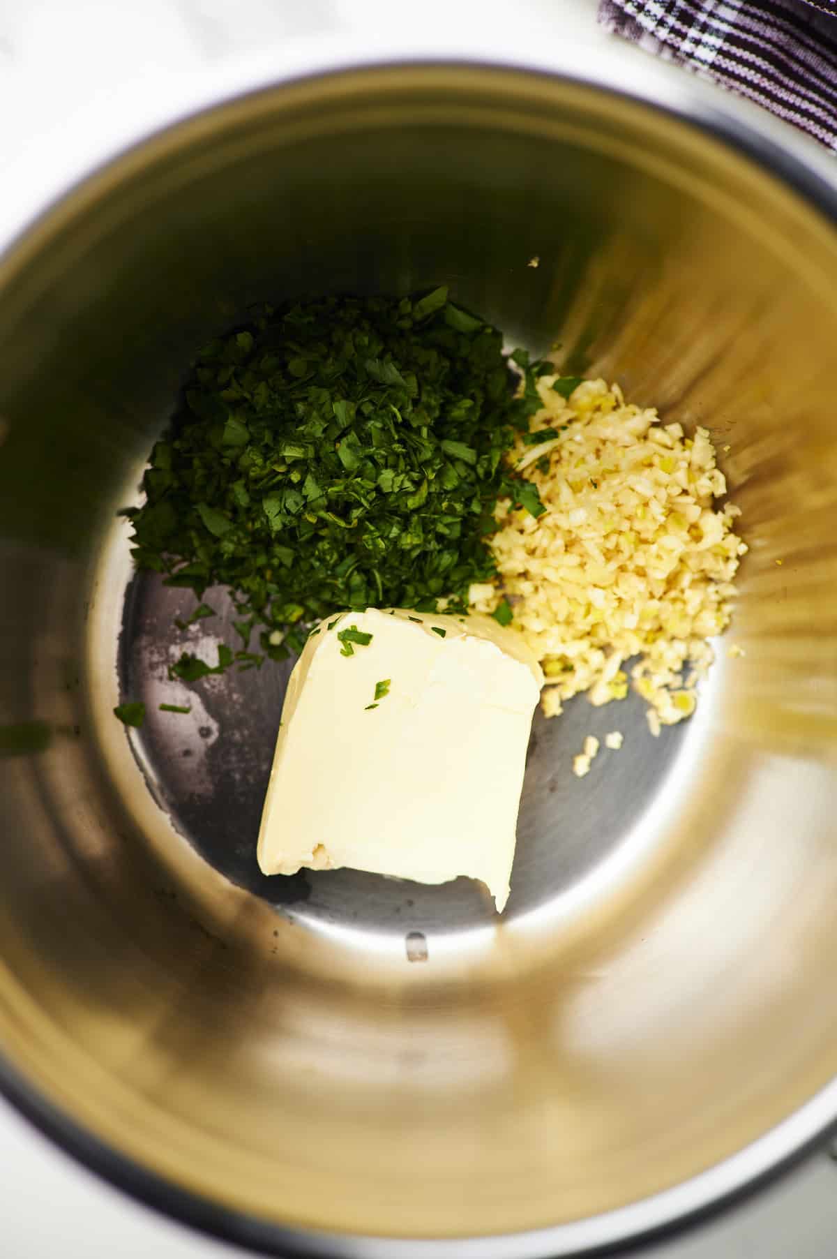 Large sauté pan filled with the ingredients to make garlic butter sauce.