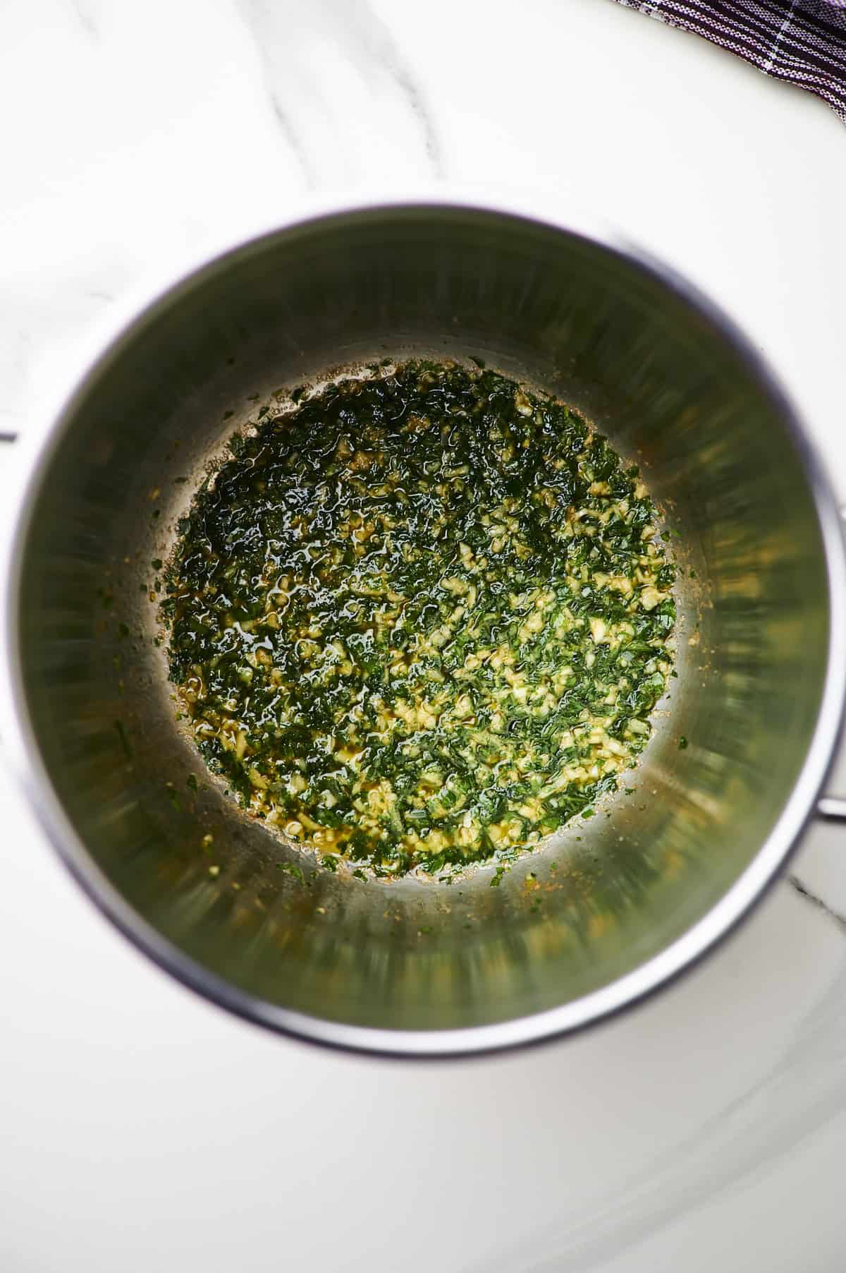 Large sauté pan filled with garlic butter sauced.