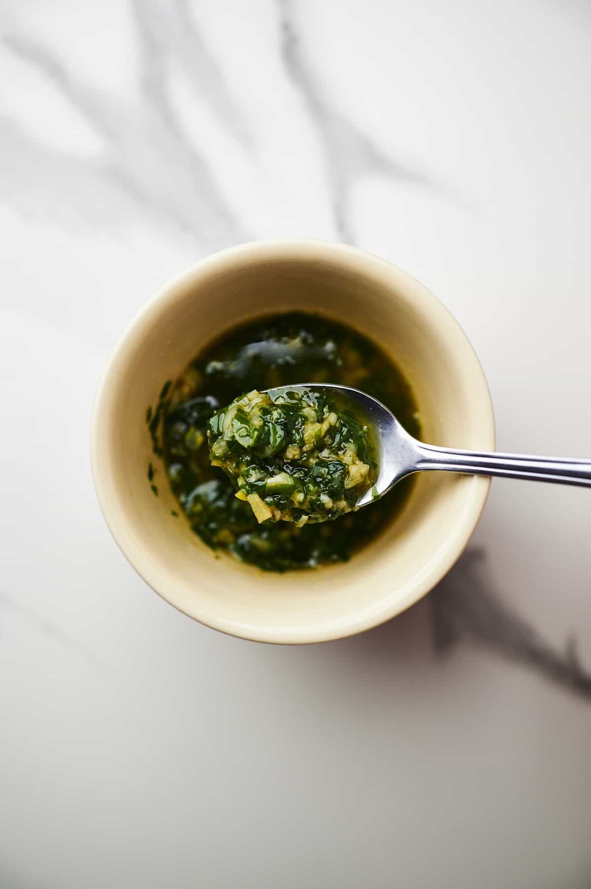 Small bowl filled with melted fresh garlic butter sauce.
