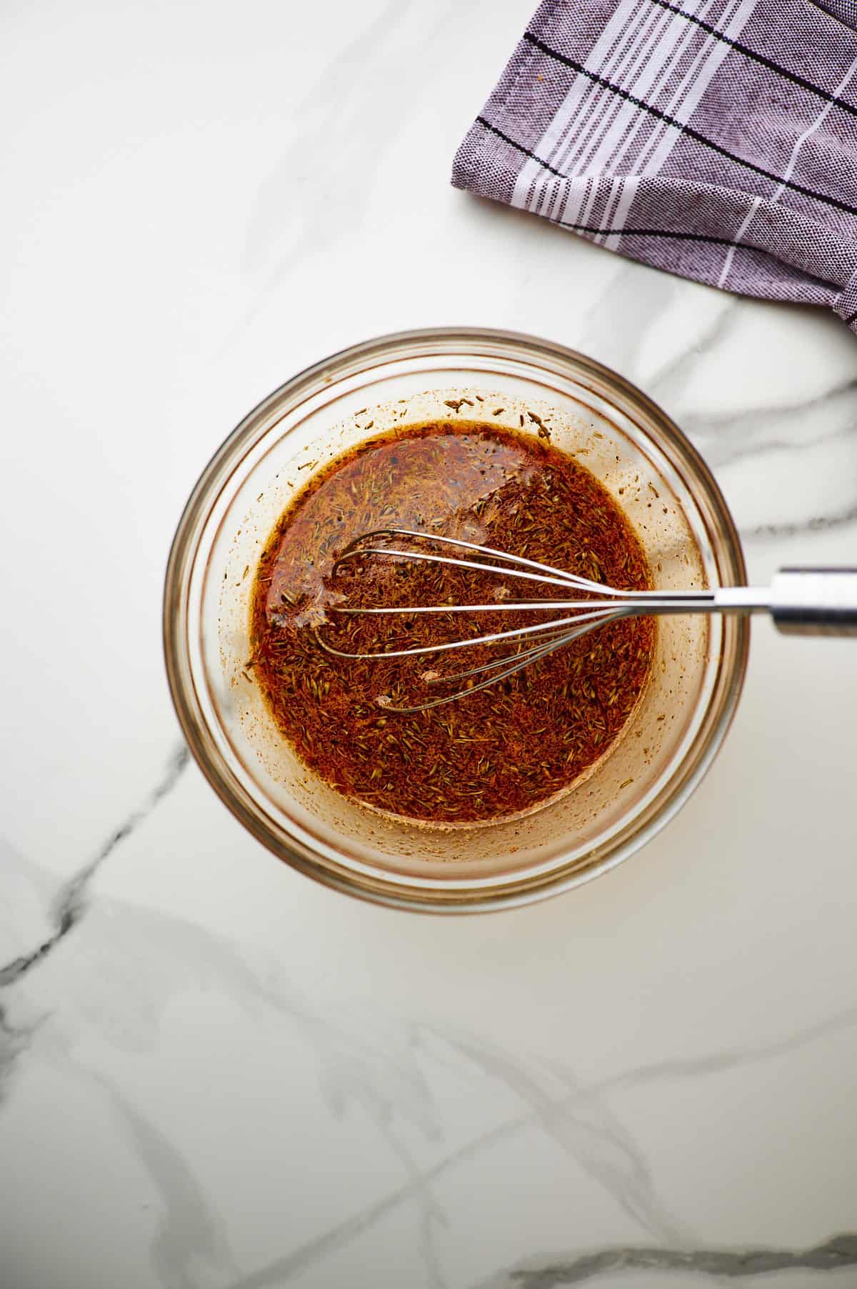 Whisking together marinade with  orange juice, soy sauce, honey, olive oil, pressed garlic, dried oregano, black pepper and paprika.