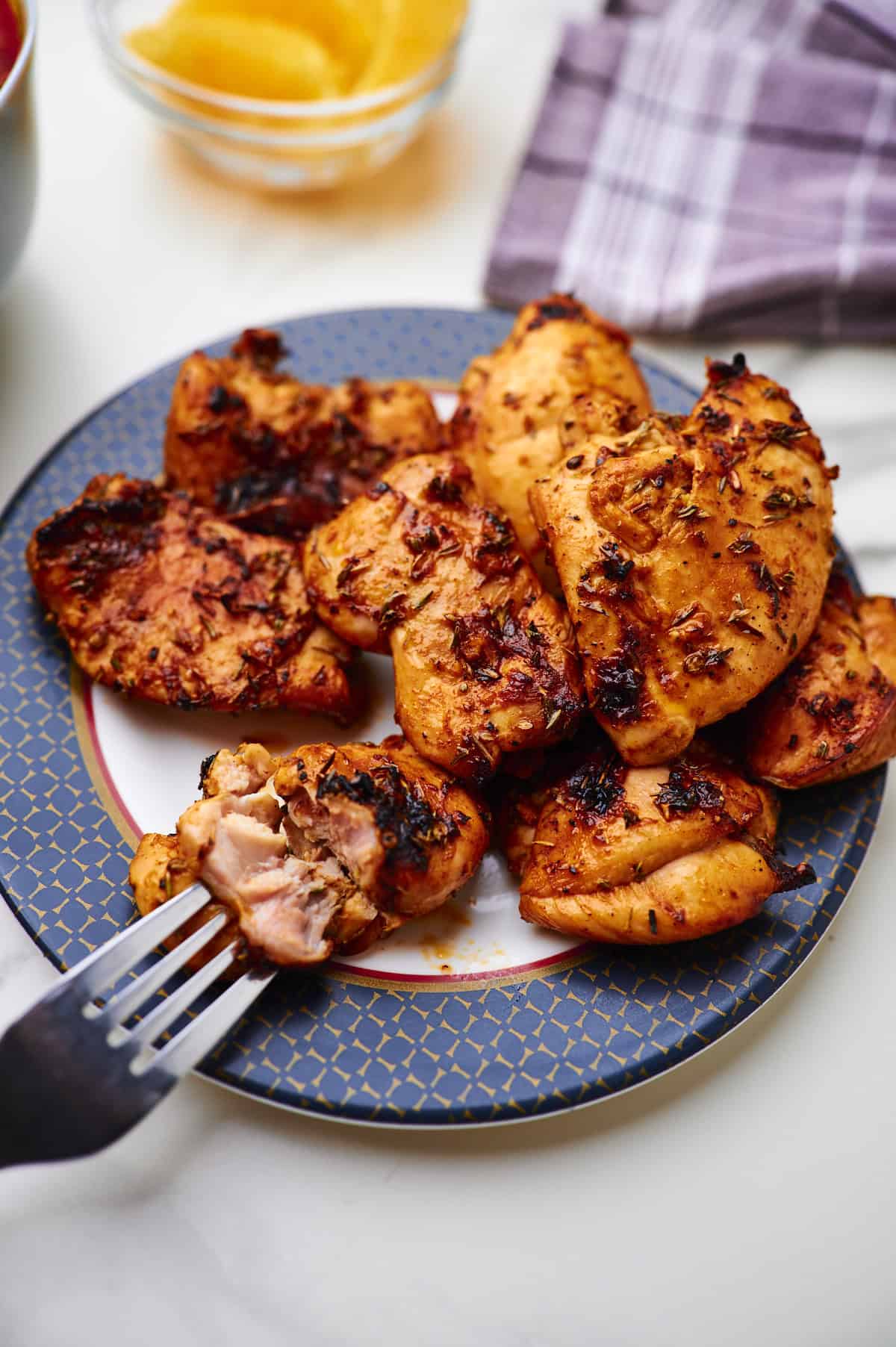 Cutting a slice of chicken thigh.