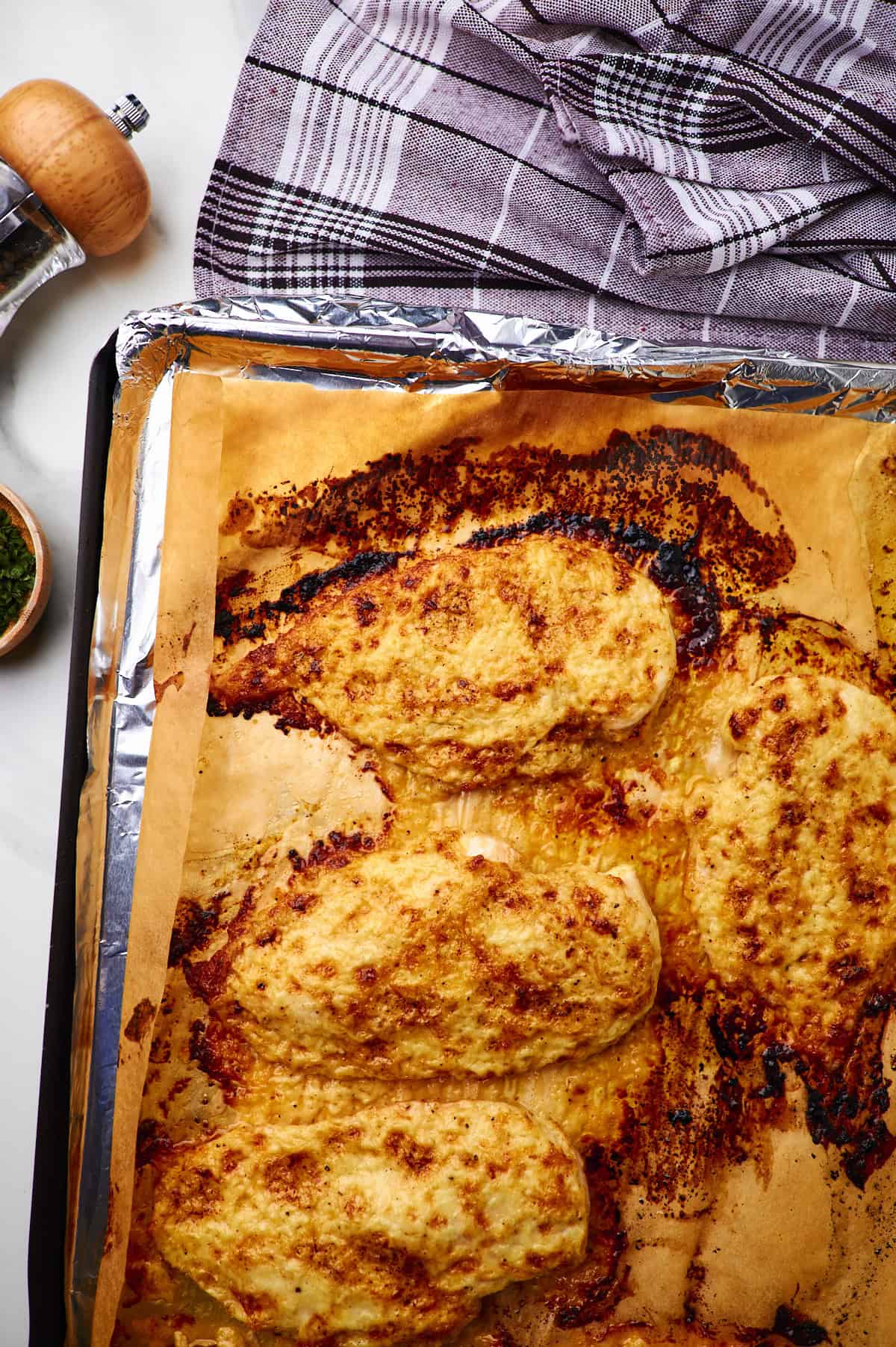 Baked Mayo Chicken on a Sheet Pan Lined with Aluminum Foil.