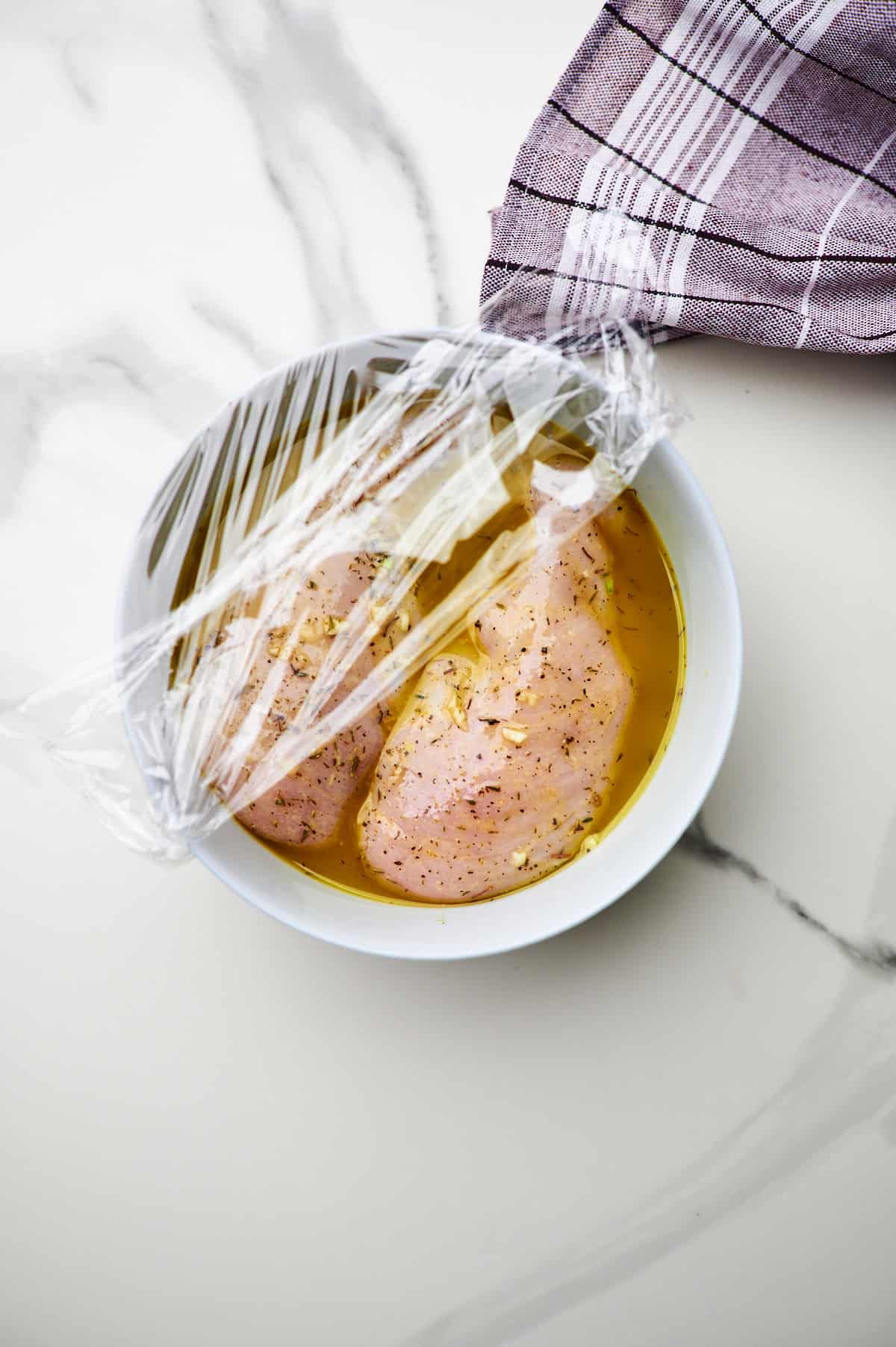 chicken breasts marinating in greek dressing