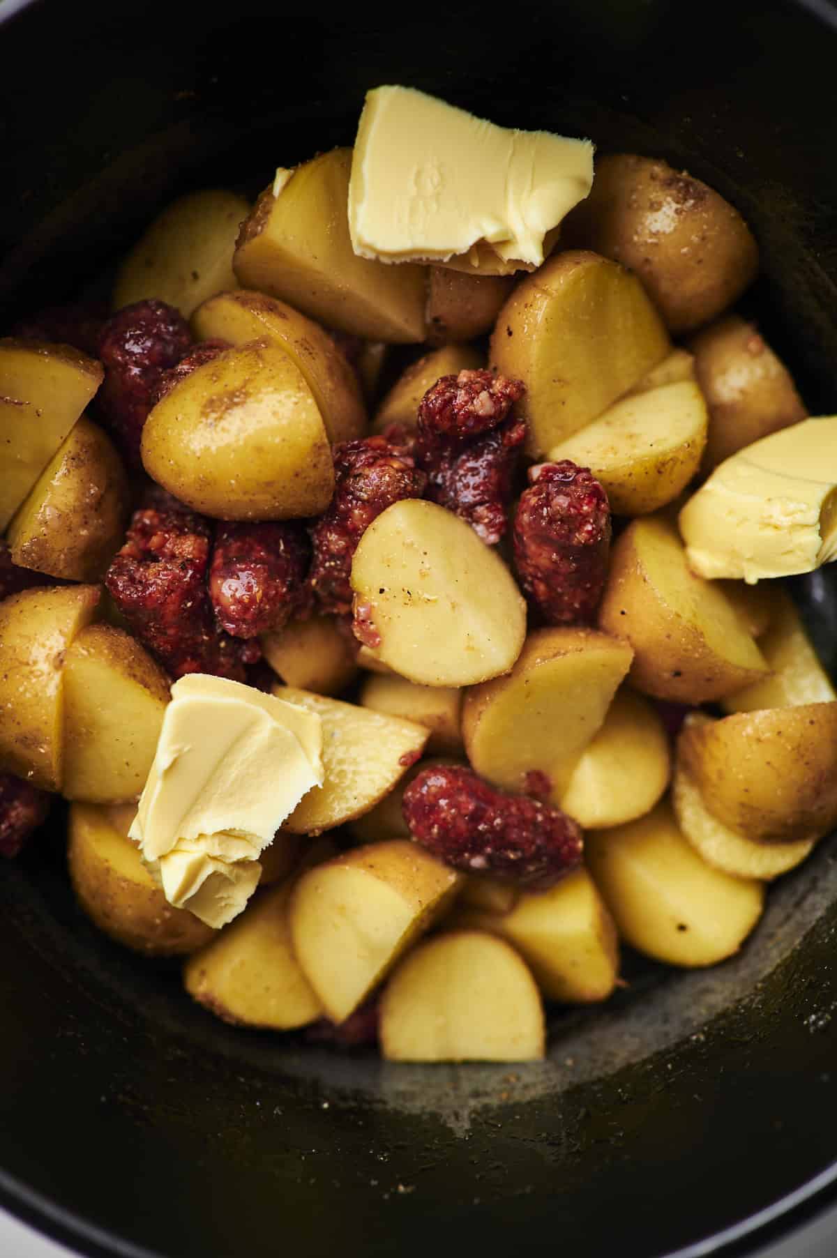 sausage, potatoes and butter in the slow cooker