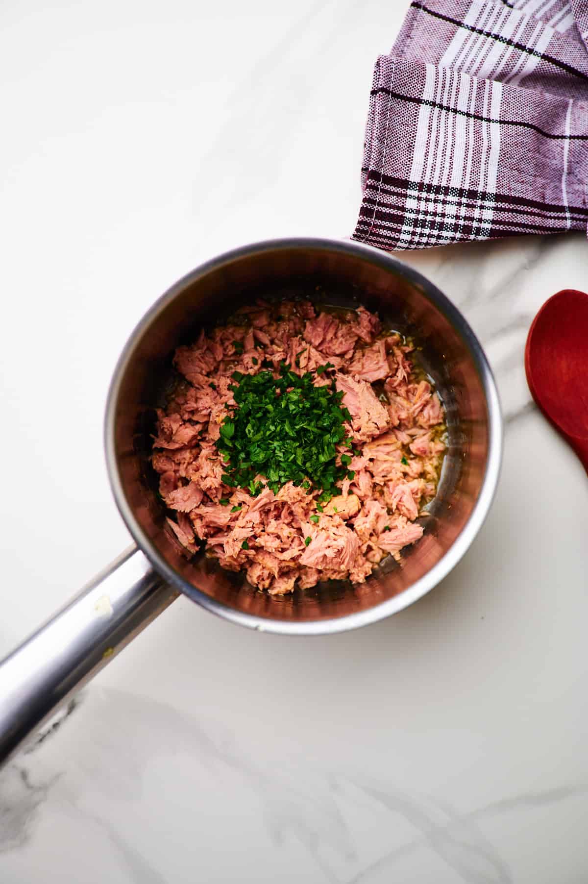 making garlic sauce in a small pan for tuna spaghetti