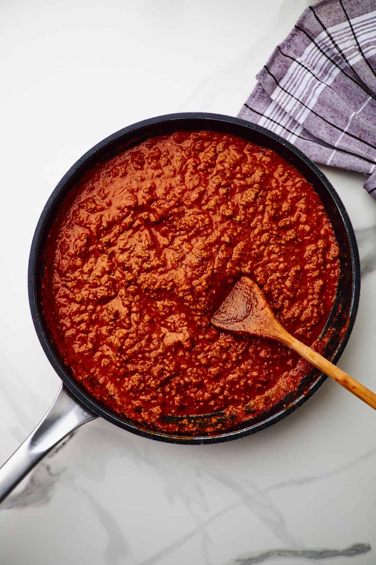 Large sauté pan filled with meaty spaghetti sauce