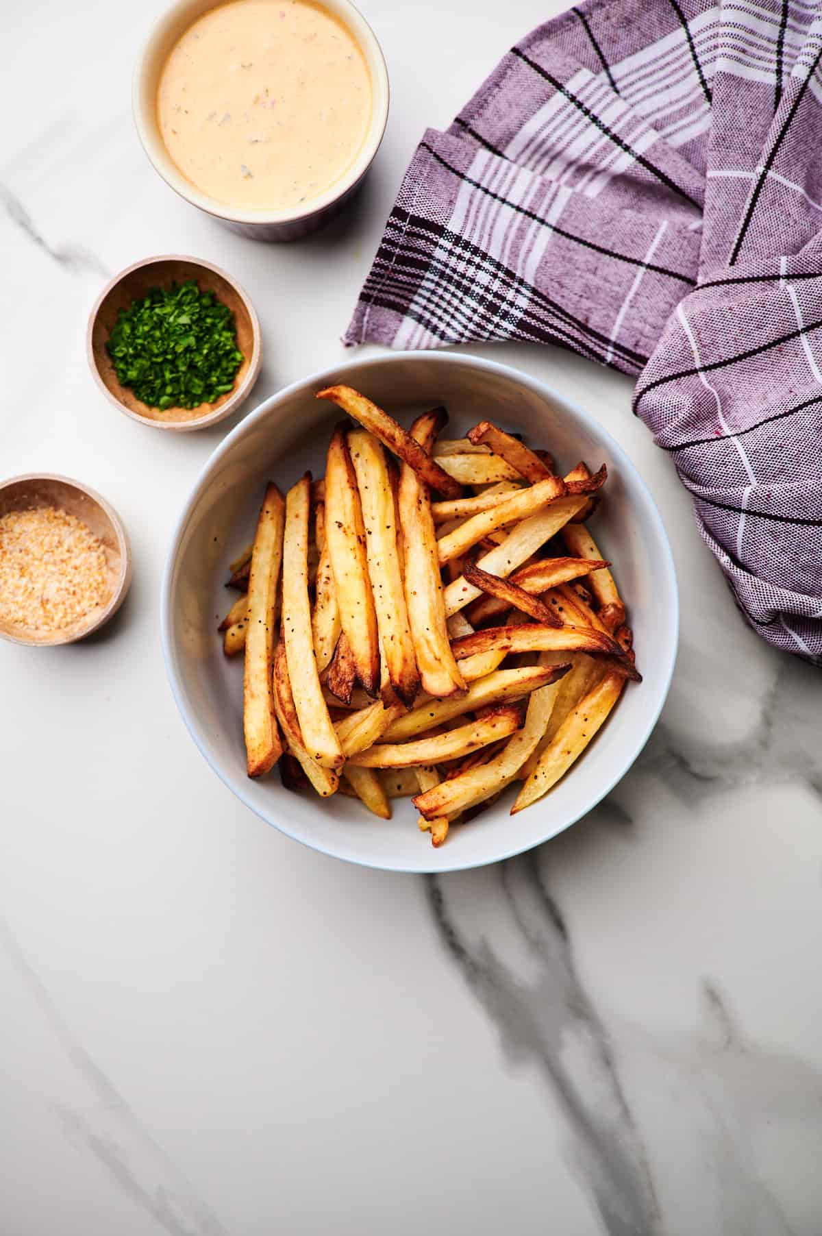 freshly fried air fryer french fries on countertop.