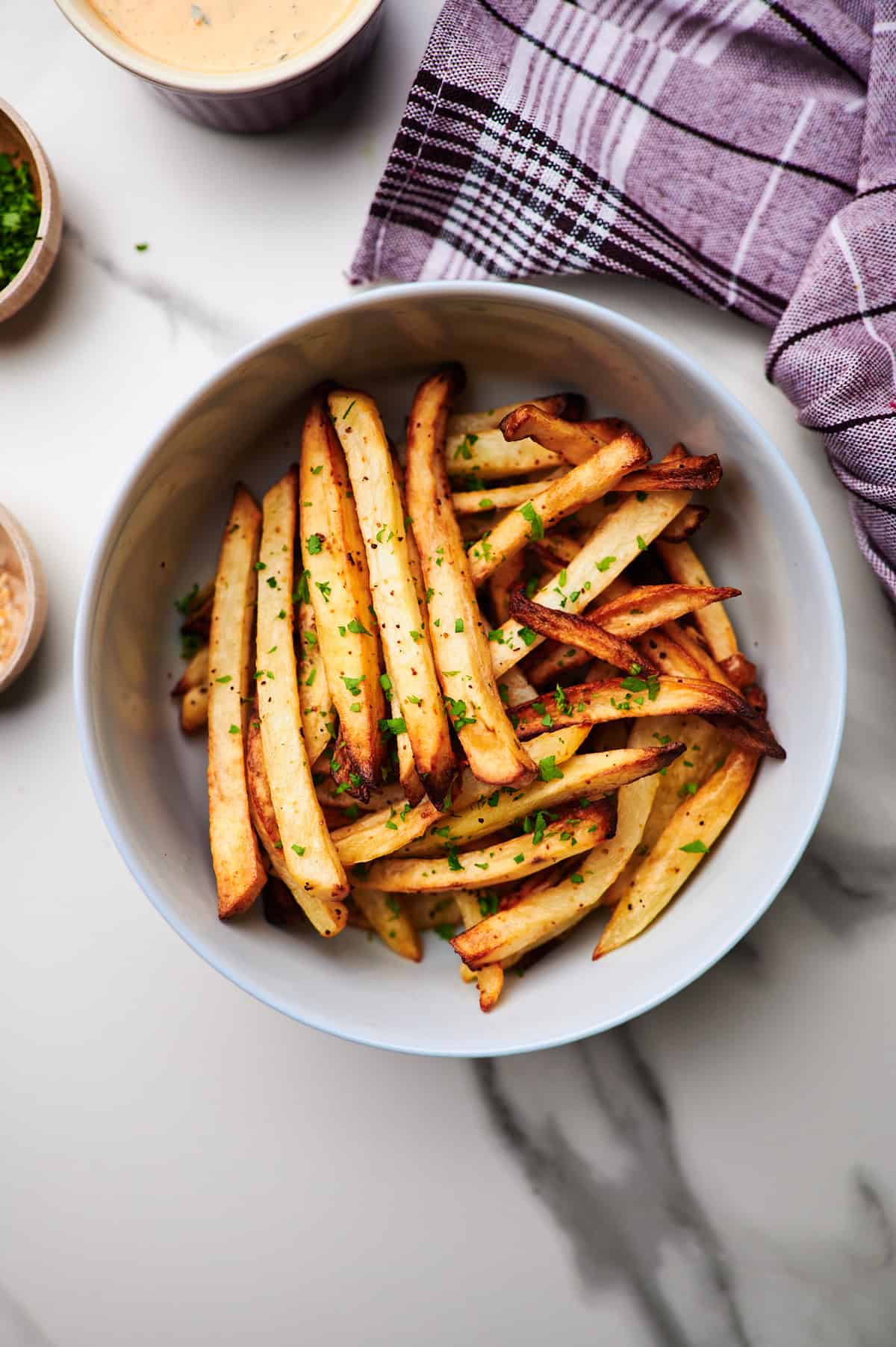 air-fried frozen french fries in bowl with parmesan cheese.
