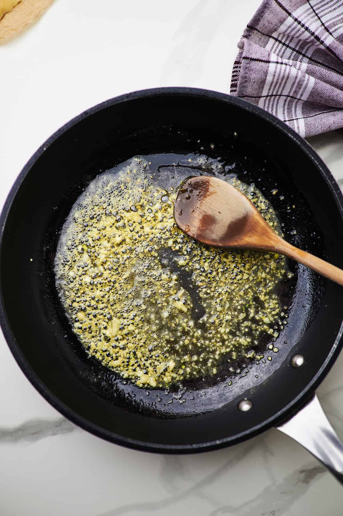 butter and garlic sautéing in a pan