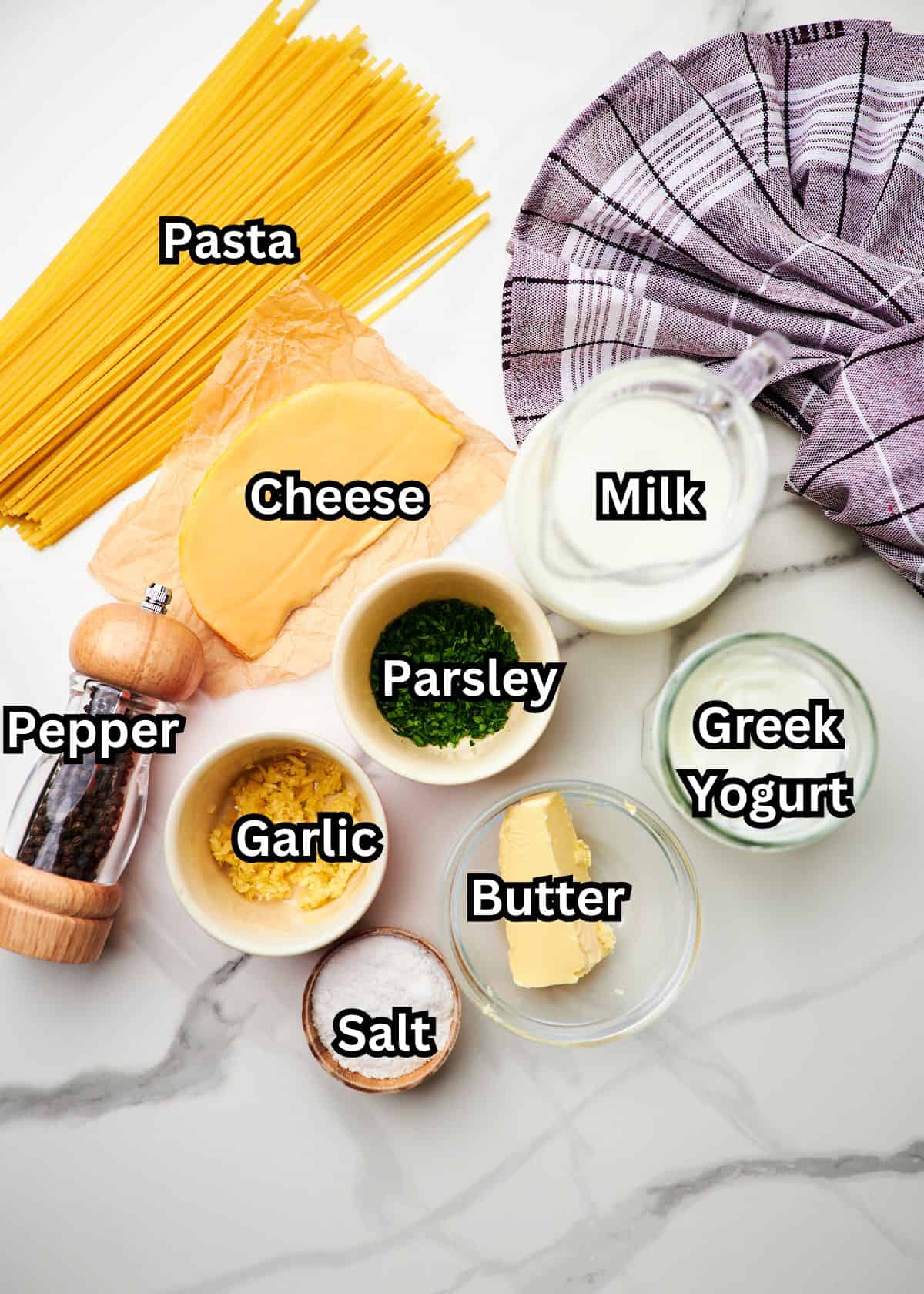 greek yogurt alfredo ingredients measured out on a white countertop