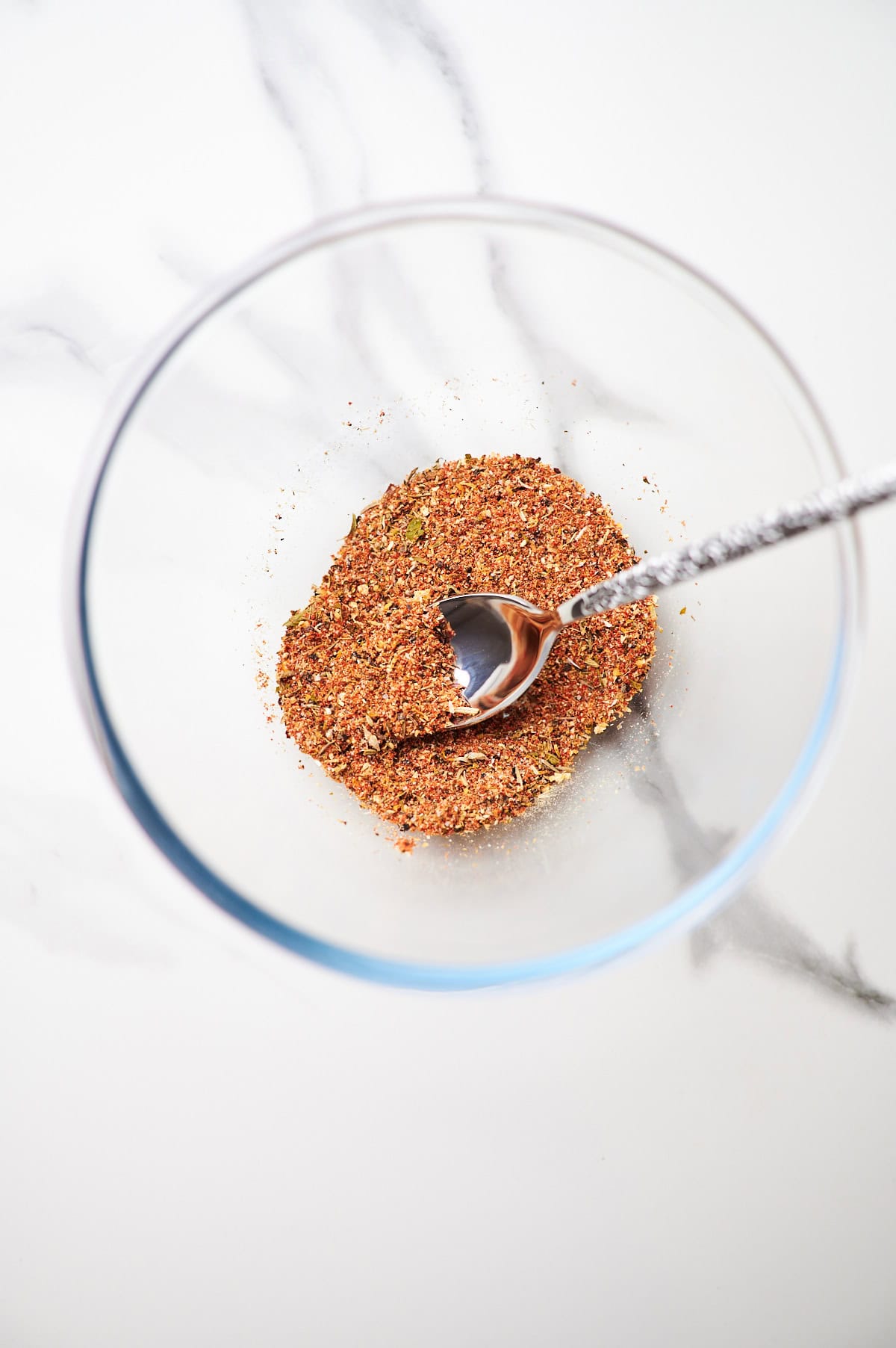Baked chicken breast seasoning in a small bowl.