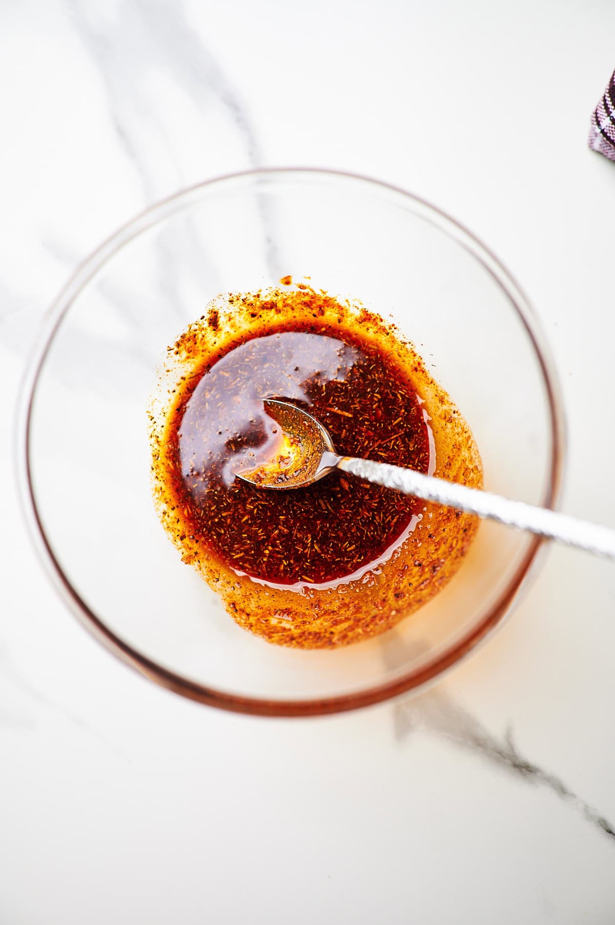 Baked chicken breast seasoning mixed with olive oil in a small bowl