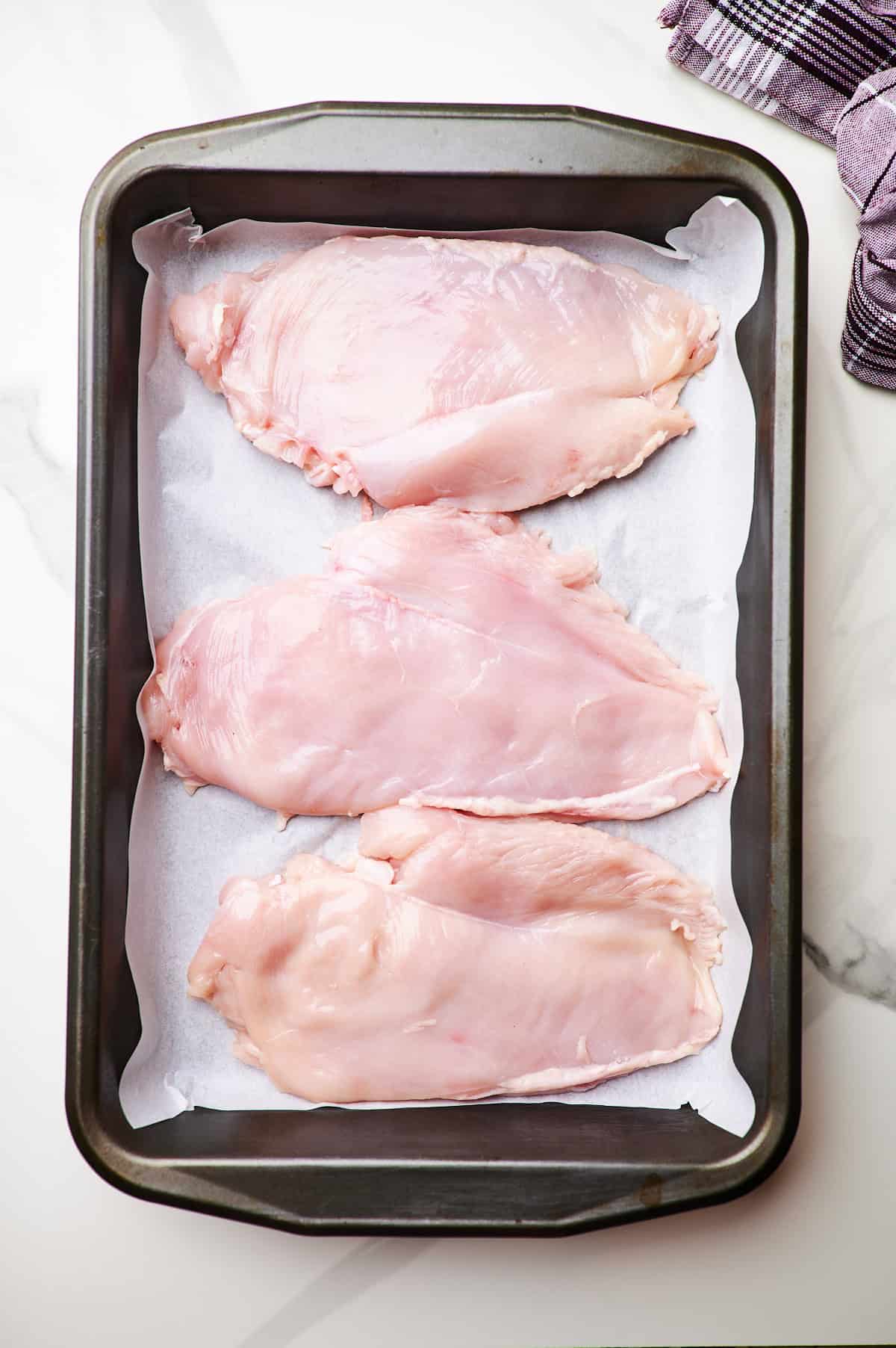chicken breasts in a baking dish.	