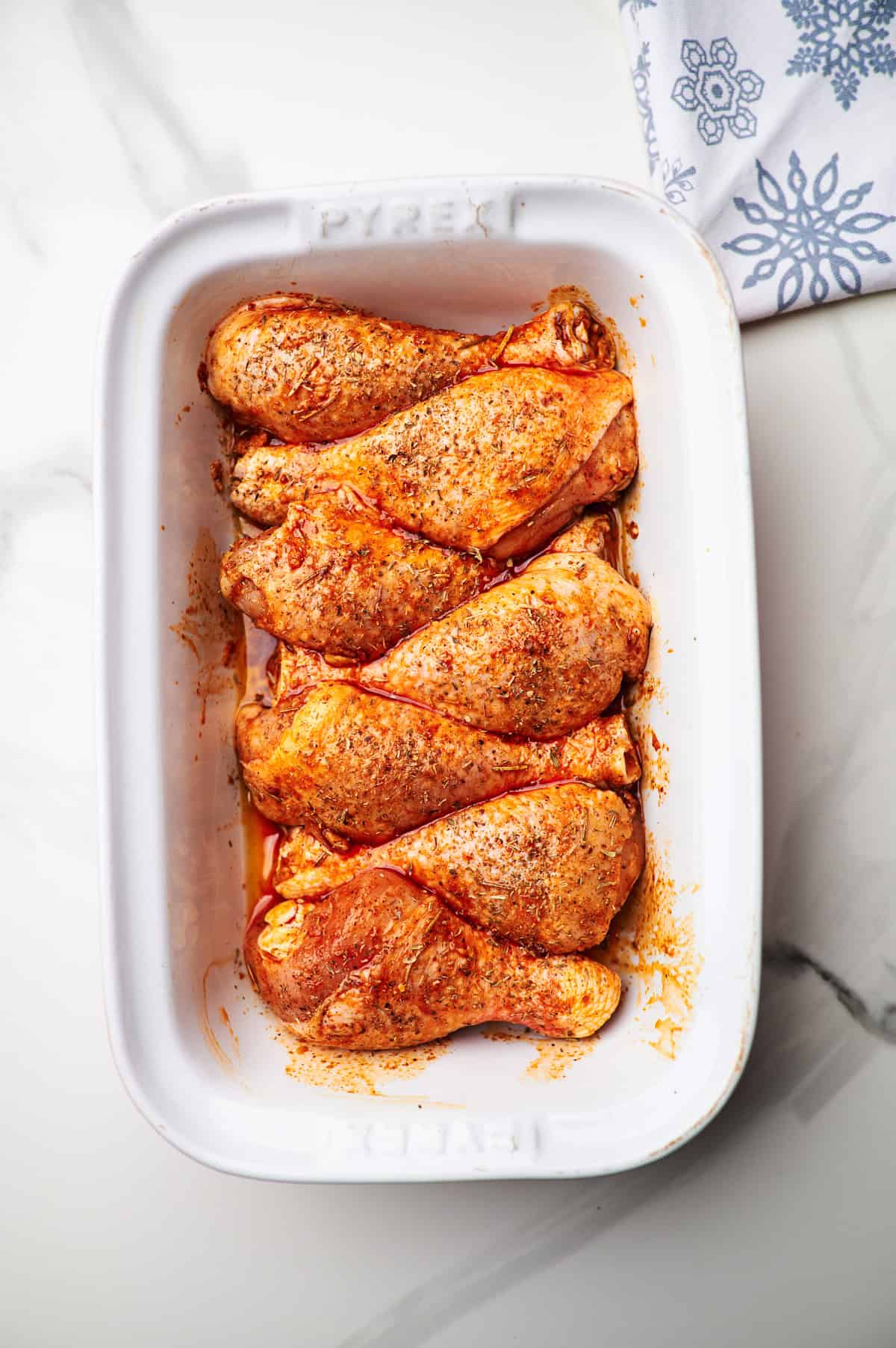 Chicken legs in a large baking dish.