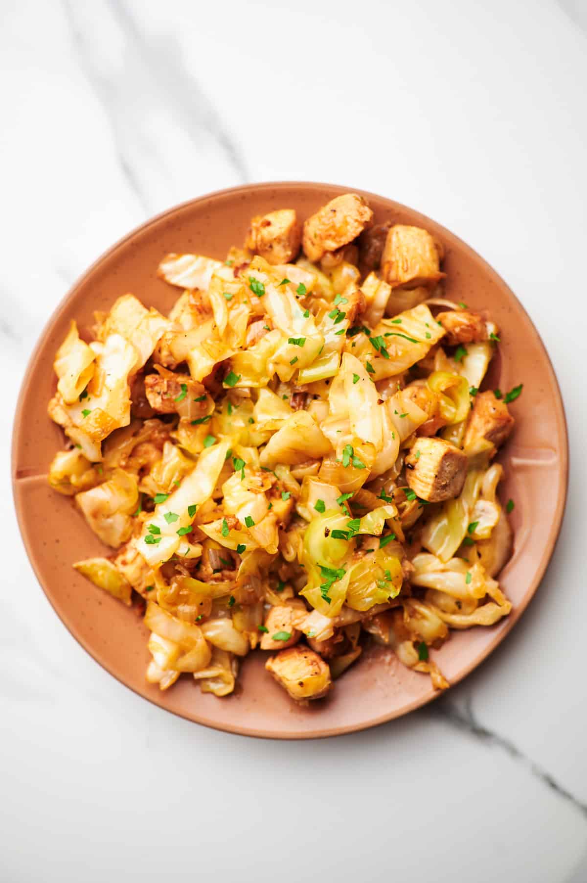 a plate with chicken and cabbage stir fry